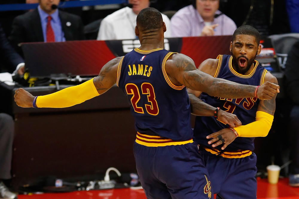 AUBURN HILLS, MI - April 22: Kyrie Irving #2 of the Cleveland Cavaliers celebrates his late fourth quarter three pointer with LeBron James #23 while playing the Detroit Pistons in game three of the NBA Eastern Conference quarterfinals at the Palace of Auburn Hills on April 22, 2016 in Auburn Hills, Michigan. NOTE TO USER: User expressly acknowledges and agrees that, by downloading and or using this photograph, User is consenting to the terms and conditions of the Getty Images License Agreement. (Photo by Gregory Shamus/Getty Images) ORG XMIT: 629953259 ORIG FILE ID: 523316554