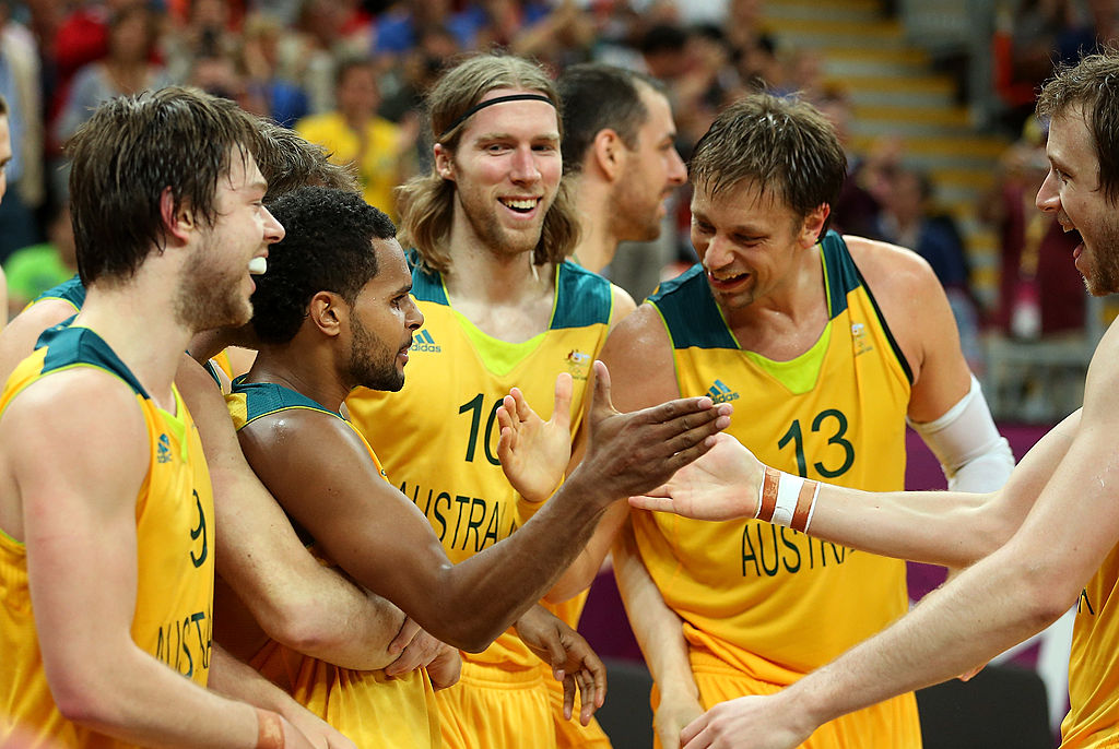 LONDON, ENGLAND - AUGUST 06: Patrick Mills #5 of Australia celebrates with David Barlow #10, David Andersen #13 and Joe Ingles #7 after making the game winning three point shot against Russia in the final seconds of the Men's Basketball Preliminary Round match on Day 10 of the London 2012 Olympic Games at the Basketball Arena on August 6, 2012 in London, England. (Photo by Christian Petersen/Getty Images)